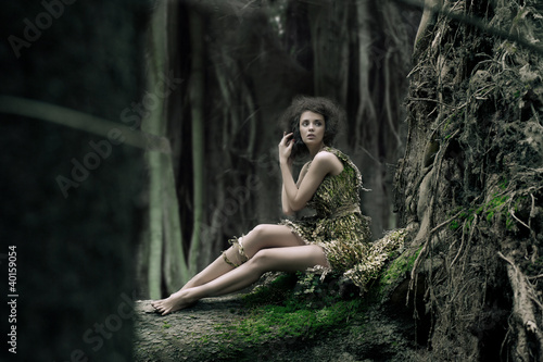 Photo: Eco woman lying on the trunk Eco woman lying on the trunk