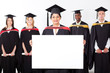 female indian graduate holding white board