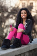Portrait of a happy young african american teenage girl listenin