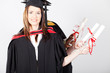 graduates holding diploma at graduation