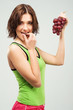 Beautiful sporty woman eating grapes Beautiful sporty woman eating grapes