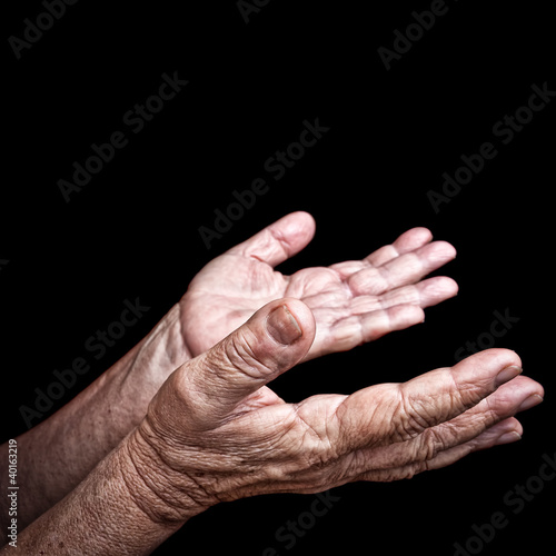 Photo: Wrinkled old hands isolated on black Wrinkled old hands isolated on black