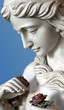 Female statue holding a rose in hand