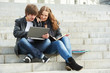 Two smiling young students outdoors