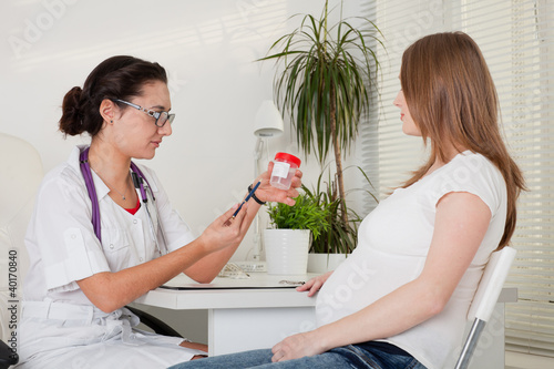 Photo: Pregnant woman and doctor. Pregnant woman and doctor.
