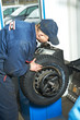 machanic repairman at tyre balancing adjustment