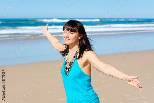 Photo: young woman enjoys her time on the beach young woman enjoys her time on the beach