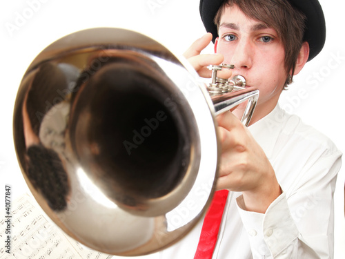 Photo: Portrait of a young man playing his Trumpet Portrait of a young man playing his Trumpet