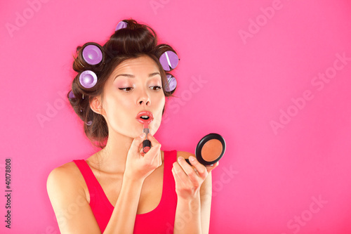 Photo: Makeup woman putting lipstick Makeup woman putting lipstick