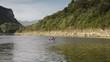 Young man on red canoe paddling for fun