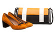 Pair of female shoes and handbag over white Pair of female shoes and handbag over white