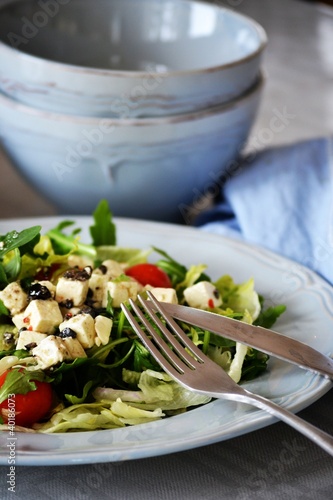 Photo: Greek salad on a blue plate Greek salad on a blue plate