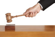 Human hand holding a wooden gavel