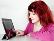 Foto: Pretty teenager is surfing on the internet with touchpad Pretty teenager is surfing on the internet with touchpad