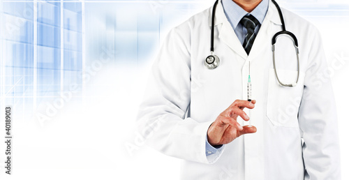 Photo: doctor in white coat holding needle doctor in white coat holding needle