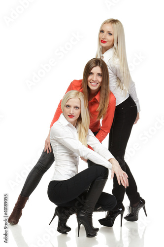 Photo: Three women fashion models posing over white Three women fashion models posing over white