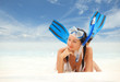 Happy woman with snorkeling equipment on the beach