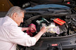 Aktiver Senior bei der Autoreparatur