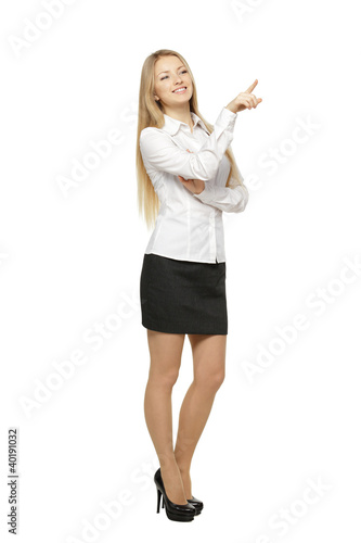 Photo: Beautiful blond business woman pointing at copy space Beautiful blond business woman pointing at copy space
