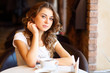Young pretty woman sitting in restaurant Young pretty woman sitting in restaurant