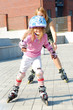 city park family rolleblading on roller skates together