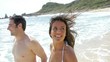 Couple in swimsuit running on the beach