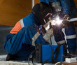 Photo: Welder working with a metal structure Welder working with a metal structure