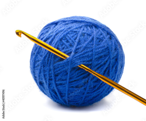 Photo: Ball of blue yarn and crochet hook Ball of blue yarn and crochet hook