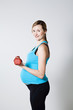 Pregnant woman exercising with dumbbells