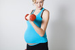 Pregnant woman exercising with dumbbells