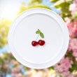 Cherry on white plate against sakura flowers