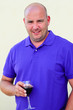 Middle aged bald man drinking red wine