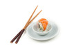 Salmon sushi on a plate with chopsticks on the side