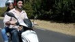 Couple riding motorbike on a country road