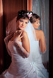 Photo: Bride standing next to the mirror Bride standing next to the mirror