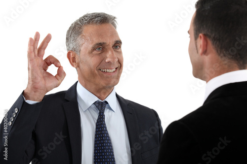 Photo: happy businessman making an okay sign happy businessman making an okay sign