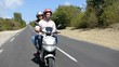 Couple riding motorbike on a country road