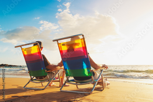 Photo: Happy Romantic Couple Enjoying Beautiful Sunset at the Beach Happy Romantic Couple Enjoying Beautiful Sunset at the Beach