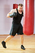 Foto: boxer man at boxing training with heavy bag boxer man at boxing training with heavy bag