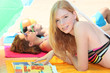 Three teenagers sunbathing together