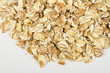 Heap of dry rolled oats isolated on white background