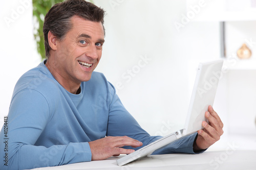 Photo: Man working at home via the internet Man working at home via the internet