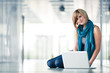 Pretty young female student with a laptop computer on college/un