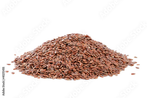 Photo: Heap Flax seeds (Linum usitatissimum) isolated on white backgrou Heap Flax seeds (Linum usitatissimum) isolated on white backgrou