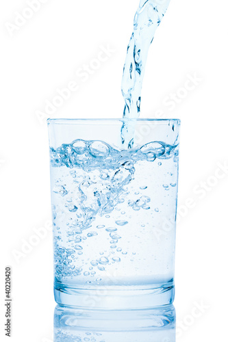 Photo: Water pouring into a glass. Water pouring into a glass.