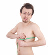 Photo: unhappy, dissatisfied young shirtless man measuring himself unhappy, dissatisfied young shirtless man measuring himself