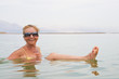 Woman floating in the Dead Sea