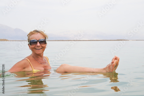 Photo: Woman floating in the Dead Sea Woman floating in the Dead Sea
