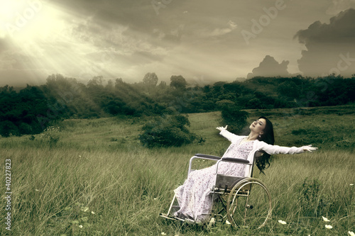 Photo: Woman in wheelchair outdoor Woman in wheelchair outdoor
