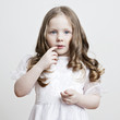Portrait of a beautiful little girl in a white dress
